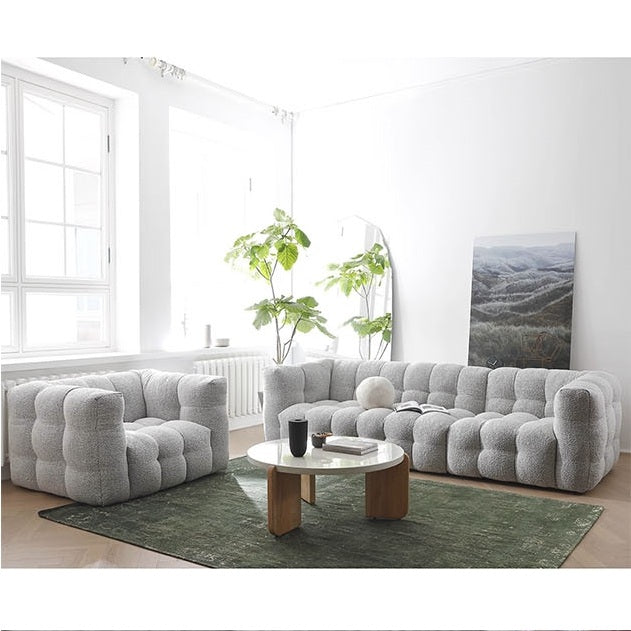 Detail view of Zobah Two Seater, Three Seater Sofa, Grey Boucle with dining table oak