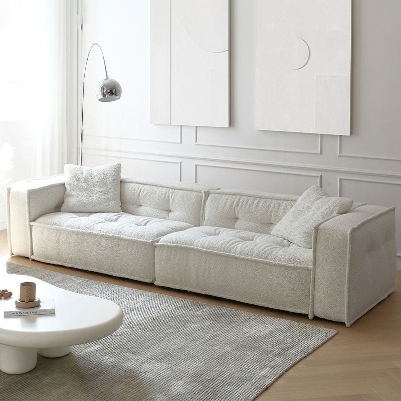 Detail view of Undra Two Seater, Three Seater Sofa, Boucle with wood circular dining table