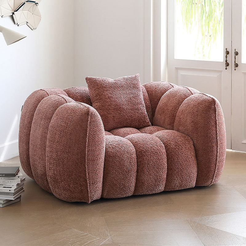 Detail view of Welton Pumpkin Armchair, Boucle with rustic oak dining table
