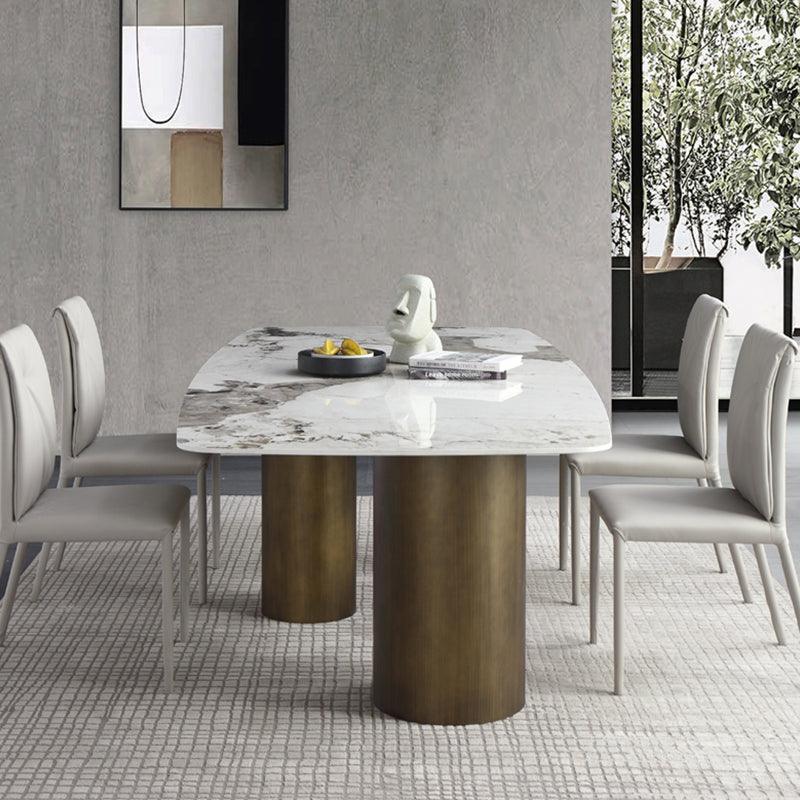 Mira Dining Table, Gold Base in a lifestyle setting with used dining table and chairs