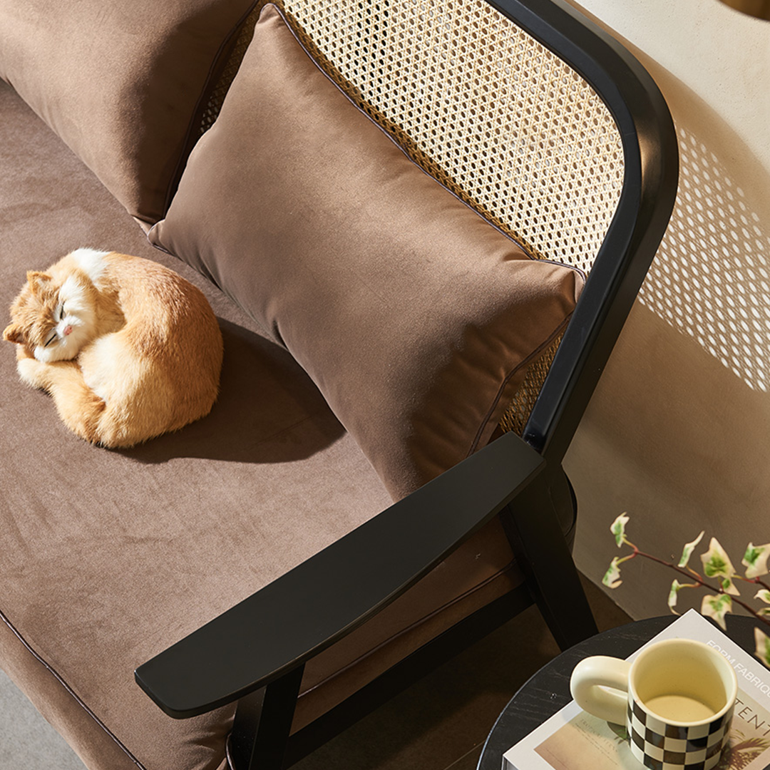 Morris Rattan Two Seater, Three Seater Sofa in a lifestyle setting with gold dining table