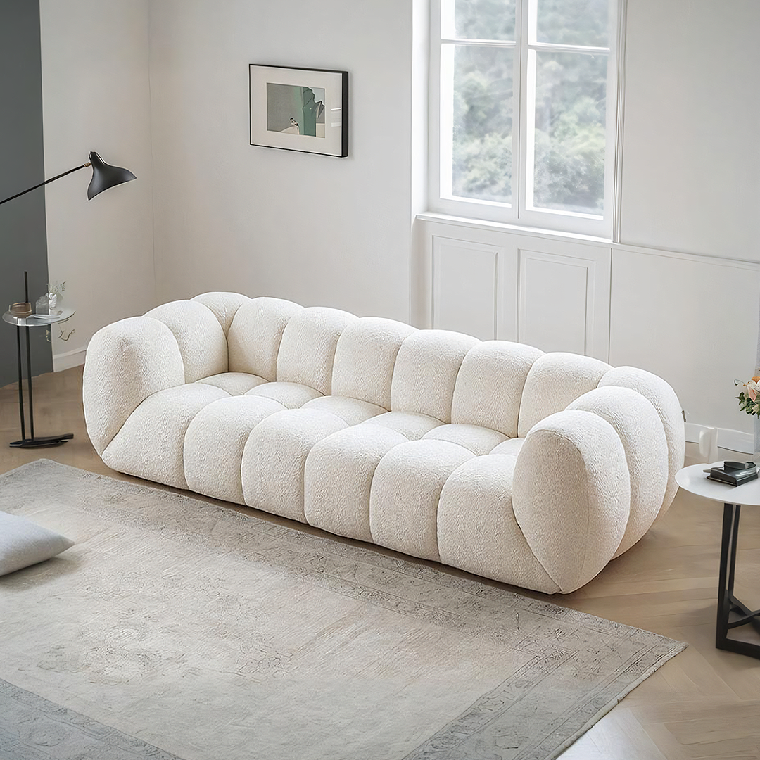 Detail view of Randee BoBo Three Seater Sofa, White Boucle with luxury dining table