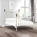 White metal bed with brass accents iconic abode
