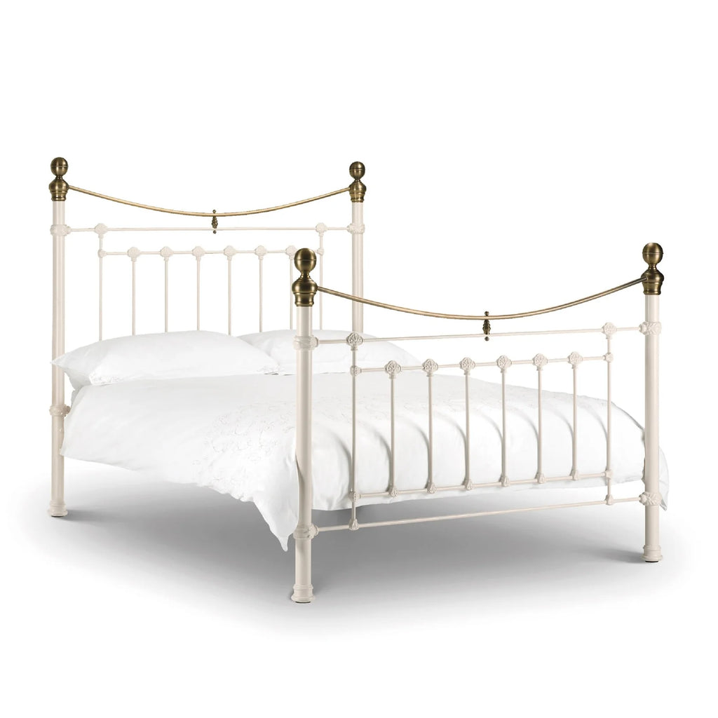 White metal bed with brass accents iconic abode