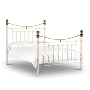 White metal bed with brass accents iconic abode
