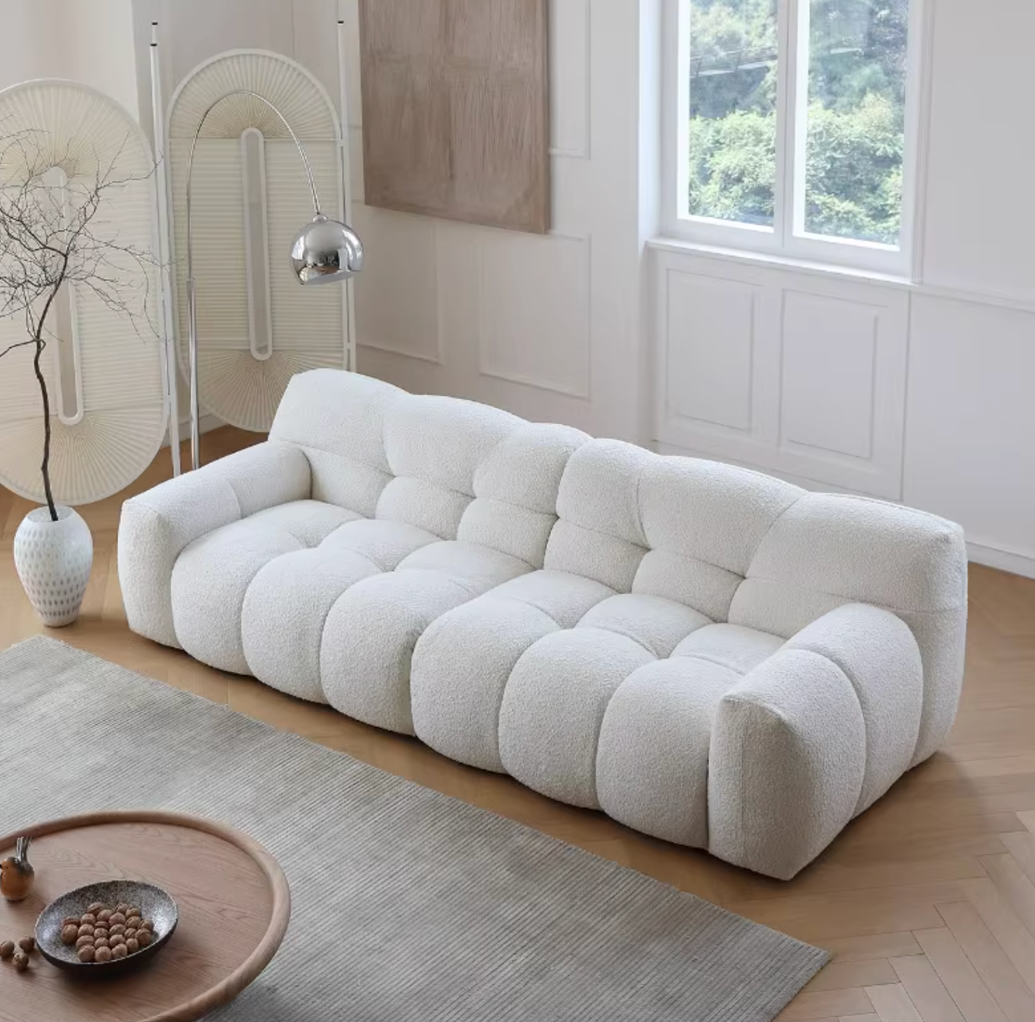 Cora Cloud Two / Three Seater Sofa, Boucle, side view of oblong wood dining table