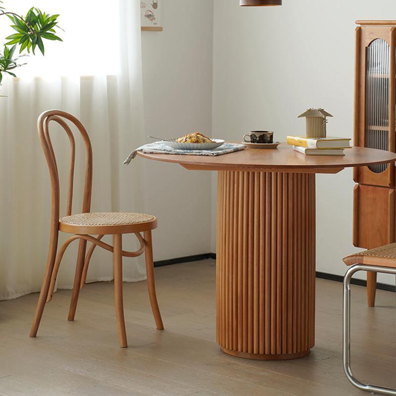 Cane Round Dining Table, Oak in a lifestyle setting with pool and dining table
