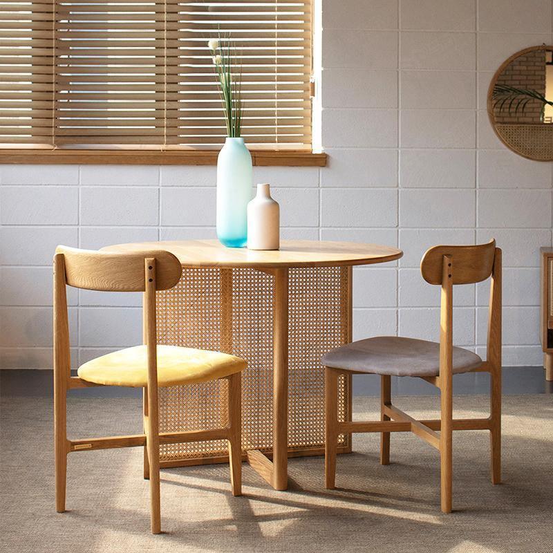 Detail view of Bruce Rattan Dining Table, Light Oak, Round with 6 seater dining room table