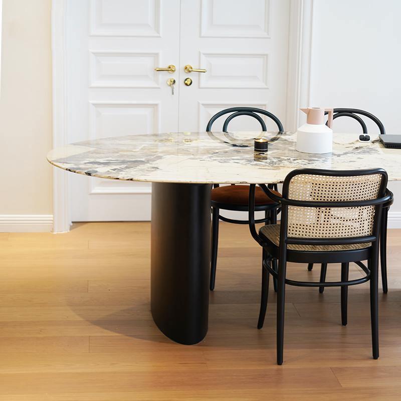 Tambo Dining Table, Pebble Shape, Sintered Stone, side view of dining table and chairs for four